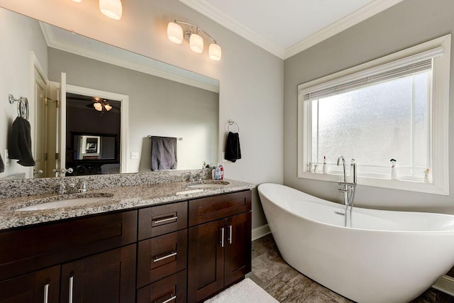 bathroom featuring vanity, crown molding, ceiling fan, and a tub