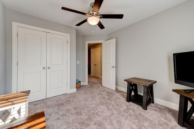 interior space with ceiling fan and light colored carpet