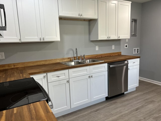 kitchen with stainless steel dishwasher, stove, sink, and wooden counters