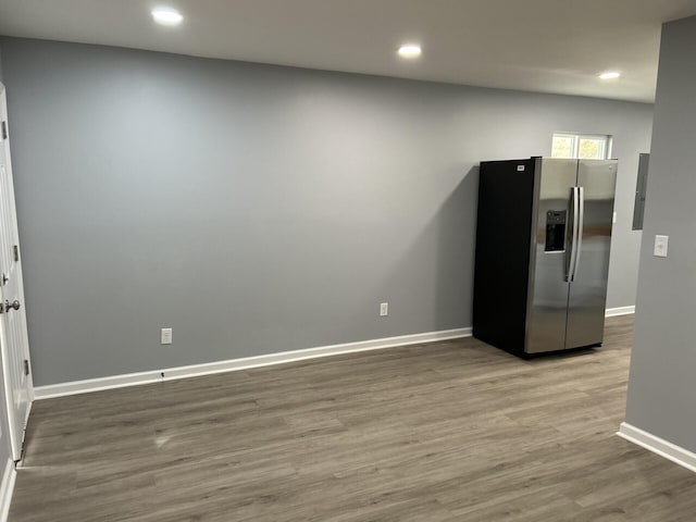 kitchen featuring stainless steel fridge and light hardwood / wood-style floors