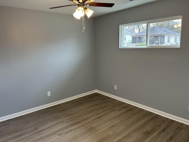 spare room featuring ceiling fan and dark wood-type flooring