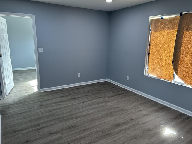 unfurnished room featuring dark hardwood / wood-style flooring