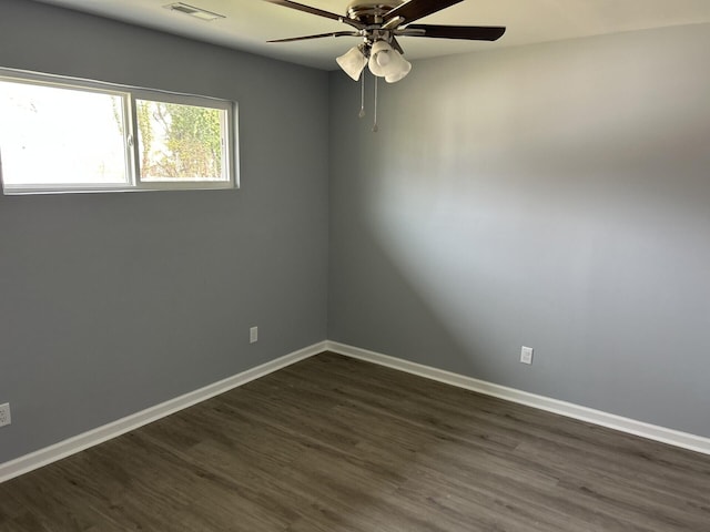 empty room with ceiling fan and dark wood-type flooring