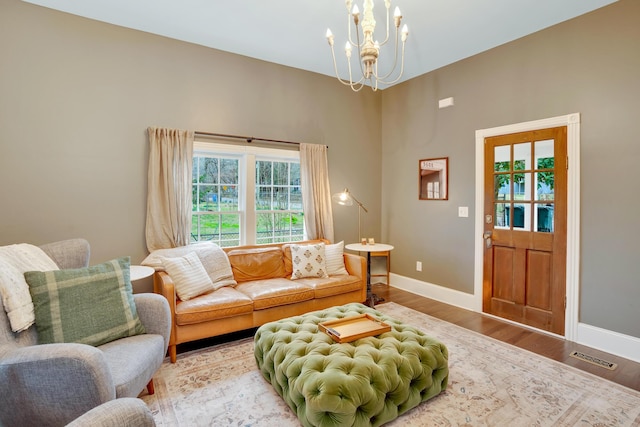 living room featuring a chandelier and wood-type flooring