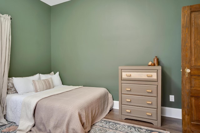 bedroom with hardwood / wood-style flooring