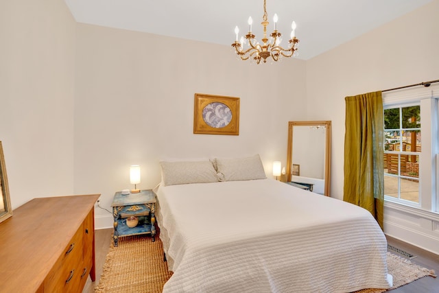 bedroom with a notable chandelier and wood-type flooring