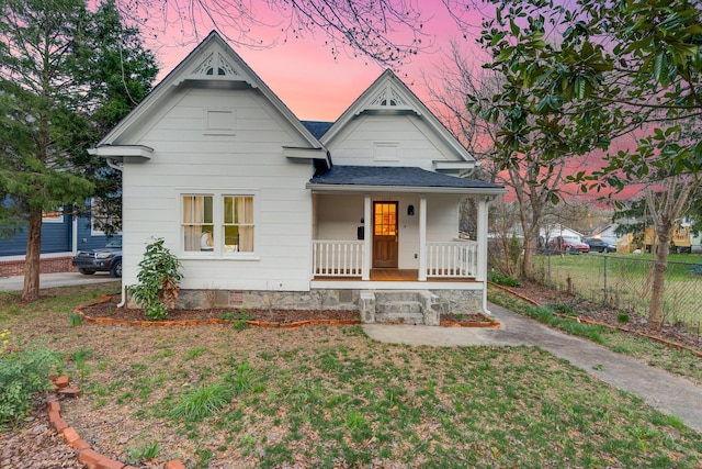 view of front facade with a lawn and a porch