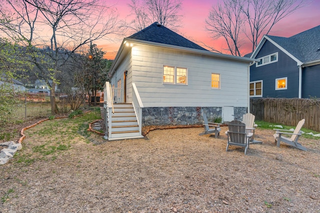 view of back house at dusk