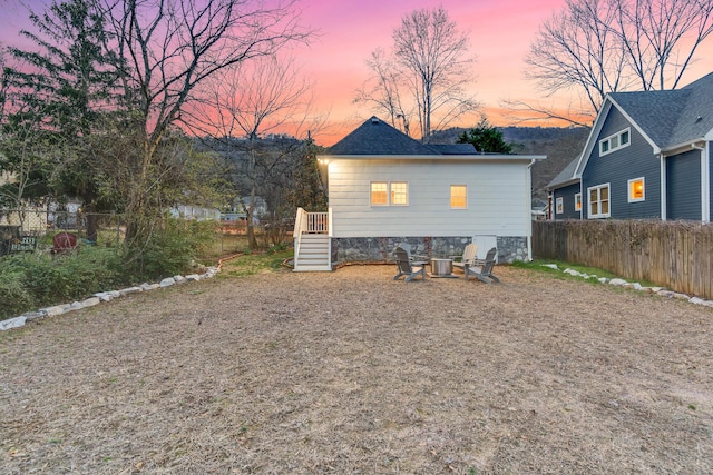 view of back house at dusk