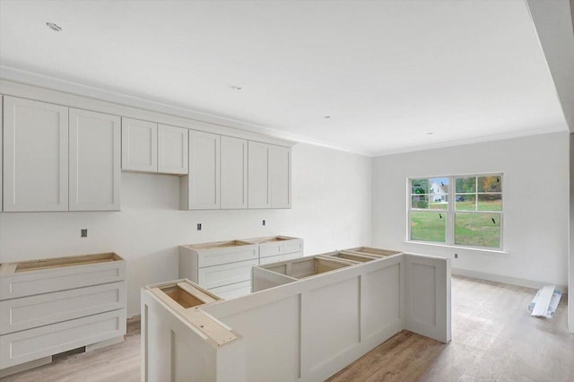 kitchen featuring a kitchen island and crown molding