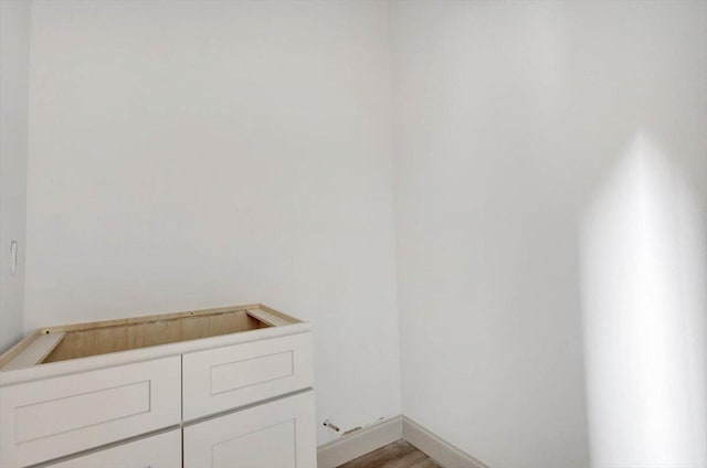 laundry area featuring hardwood / wood-style flooring