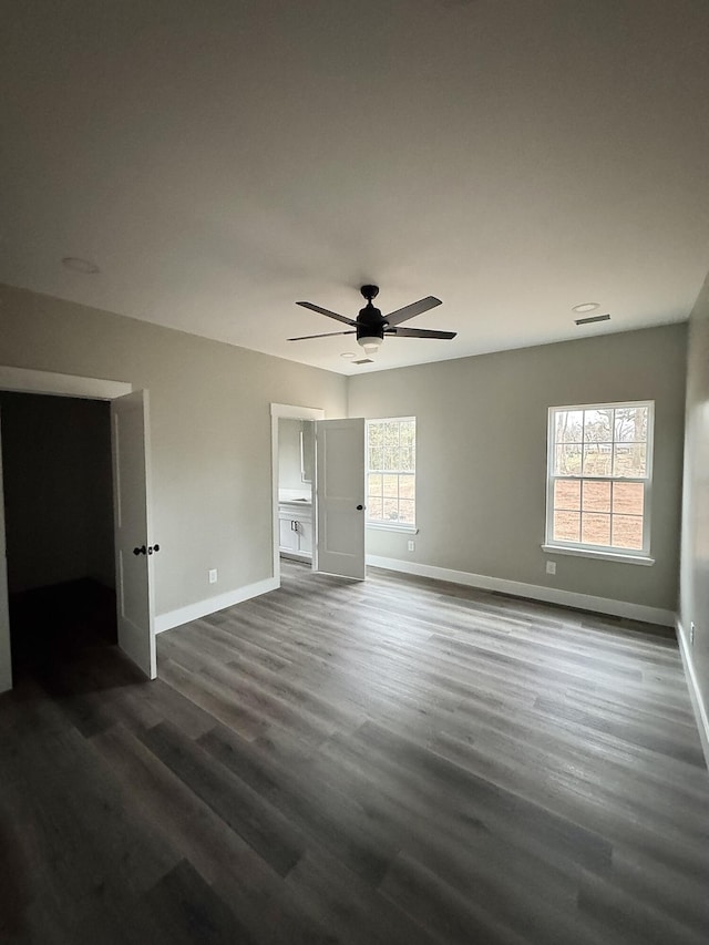 unfurnished bedroom featuring ceiling fan and dark hardwood / wood-style floors