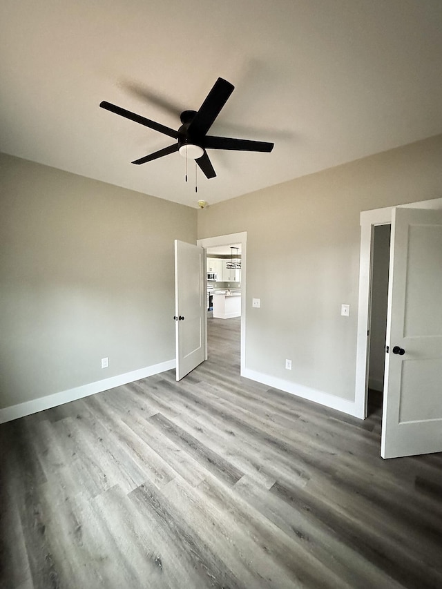 unfurnished bedroom with ceiling fan and light hardwood / wood-style flooring