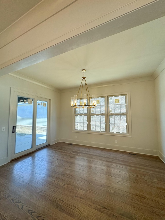 unfurnished dining area featuring dark hardwood / wood-style floors, an inviting chandelier, and ornamental molding