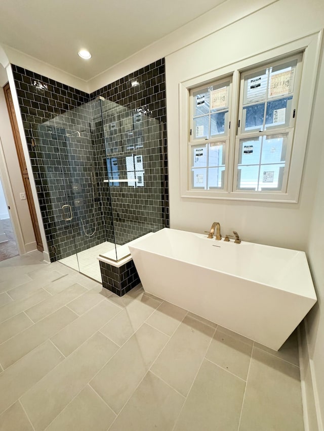 bathroom featuring tile patterned flooring and shower with separate bathtub