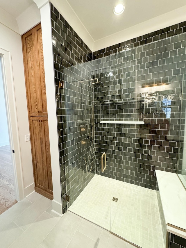 bathroom with tile patterned floors and a shower with shower door