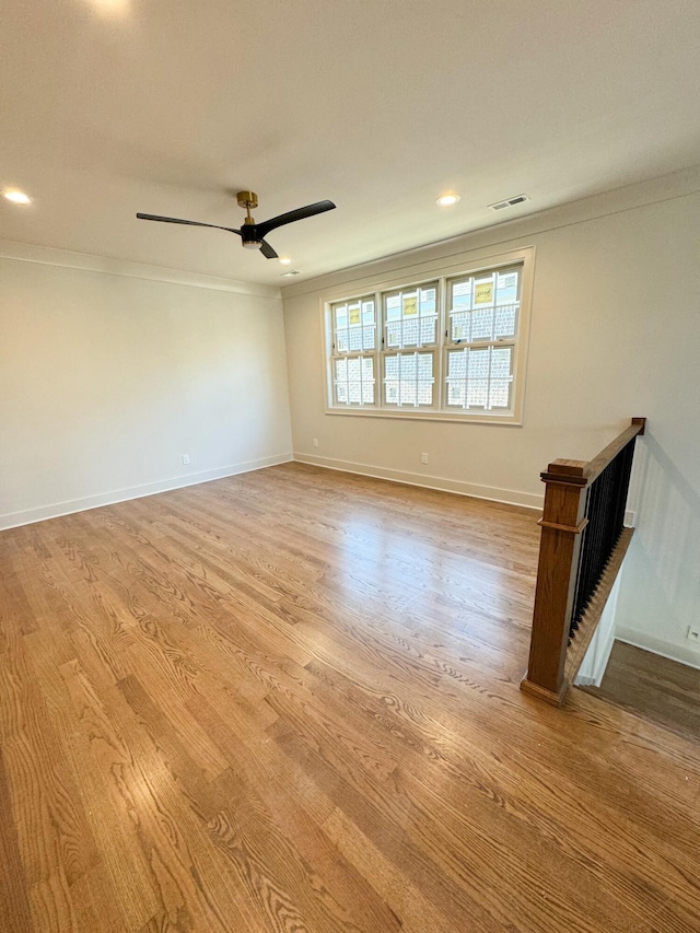 empty room featuring light hardwood / wood-style floors, ceiling fan, and ornamental molding