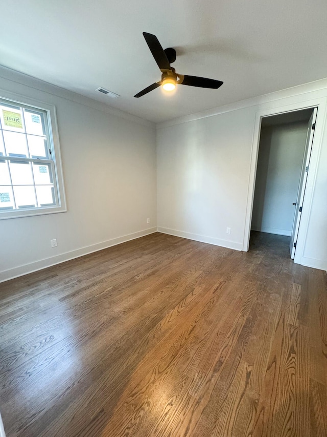 spare room featuring ceiling fan, dark hardwood / wood-style floors, and ornamental molding