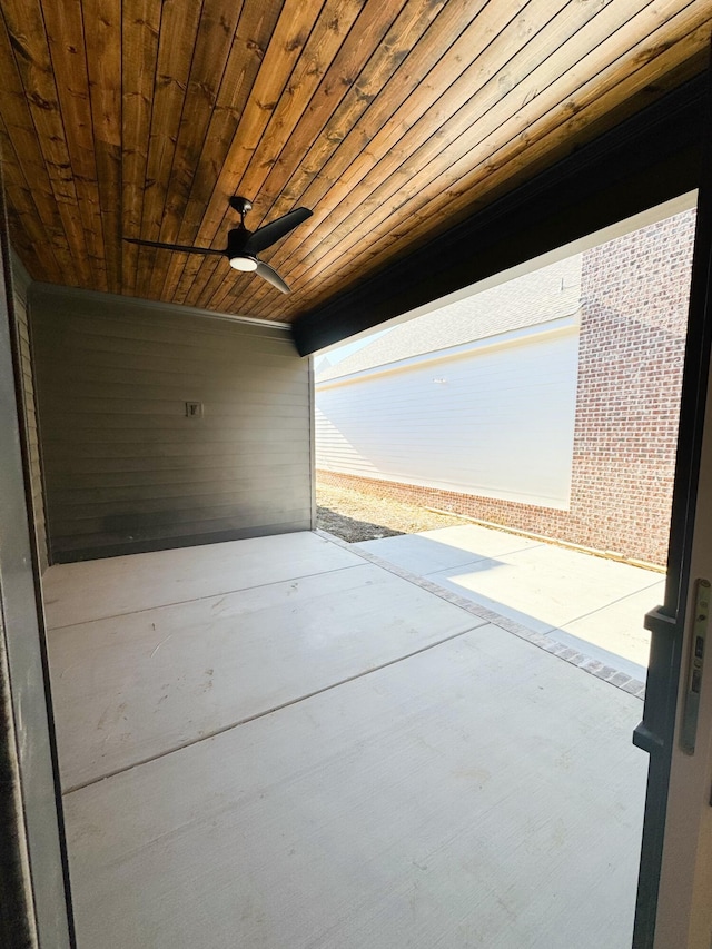 interior space featuring ceiling fan and wooden ceiling