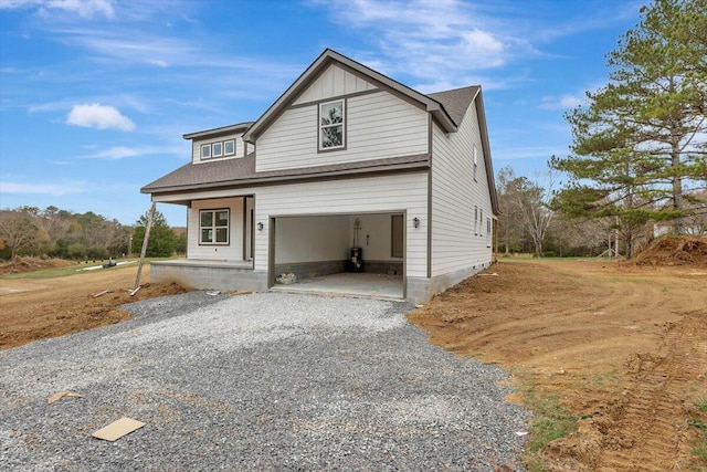 view of front of home featuring covered porch and a garage