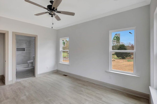 unfurnished bedroom with connected bathroom, light hardwood / wood-style floors, ceiling fan, and crown molding