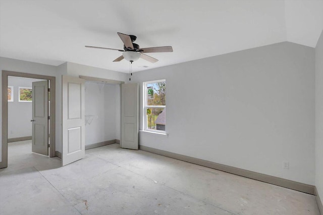 unfurnished bedroom with multiple windows, ceiling fan, and lofted ceiling