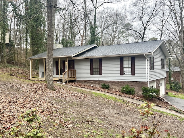 ranch-style house with a garage and a porch