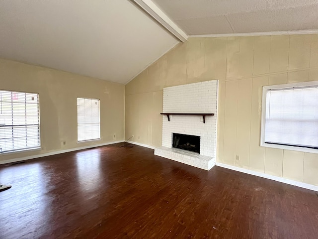 unfurnished living room featuring a fireplace, dark hardwood / wood-style floors, and lofted ceiling with beams