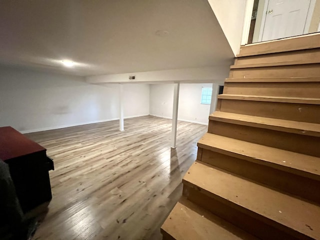 basement with hardwood / wood-style flooring