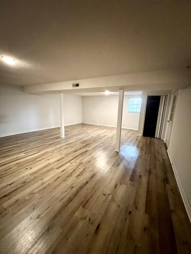 basement featuring wood-type flooring