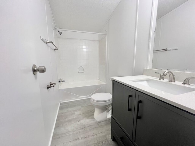 full bathroom with vanity, wood-type flooring, a textured ceiling, and tub / shower combination