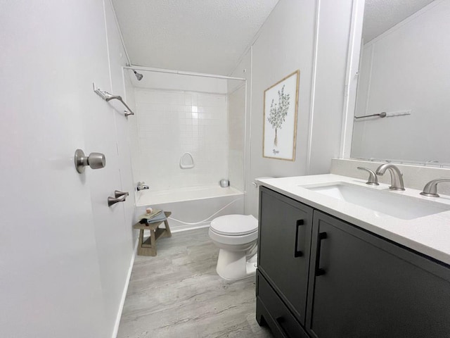 full bathroom featuring hardwood / wood-style flooring, vanity, shower / bathtub combination, and a textured ceiling