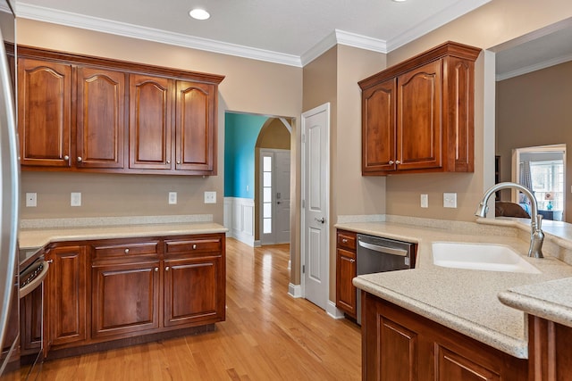 kitchen with dishwasher, light hardwood / wood-style floors, crown molding, and sink