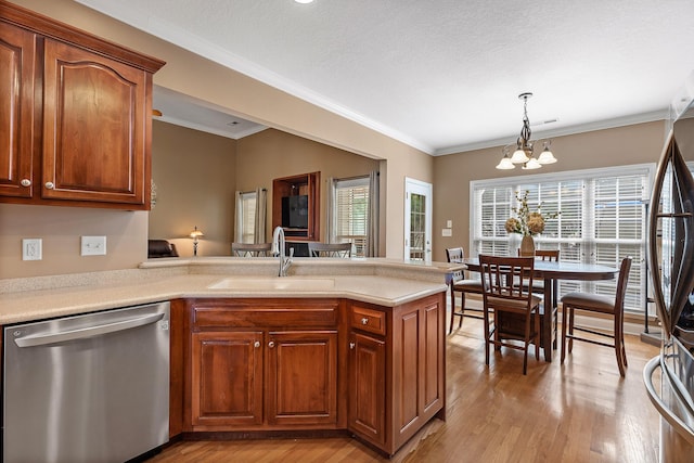 kitchen with sink, an inviting chandelier, light hardwood / wood-style flooring, decorative light fixtures, and appliances with stainless steel finishes