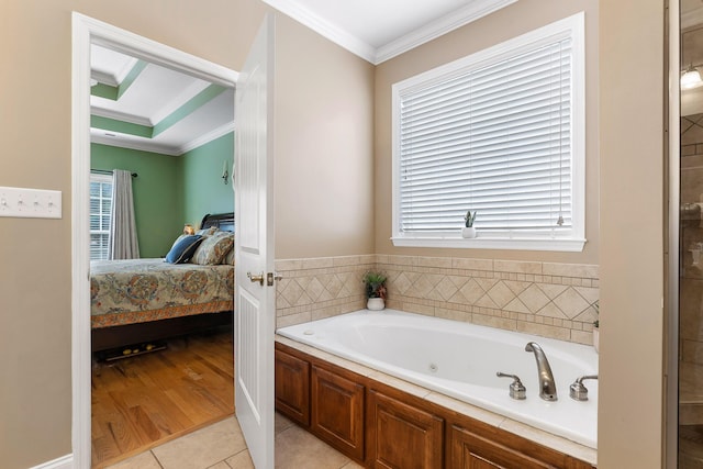 bathroom featuring a bathing tub, tile patterned floors, and crown molding