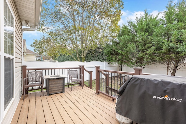 wooden terrace featuring a grill