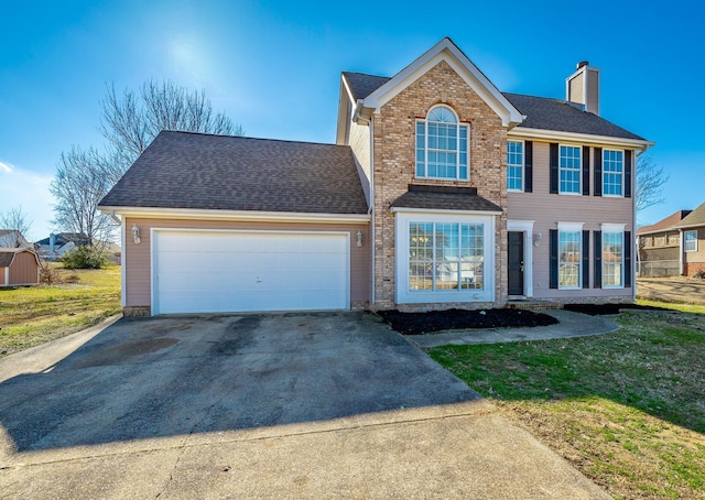 view of front of home featuring a garage and a front lawn