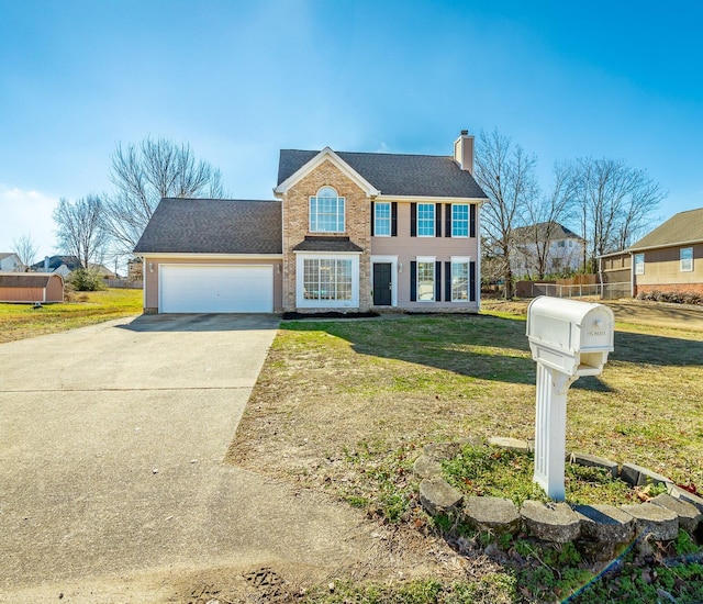 colonial inspired home featuring a front yard and a garage