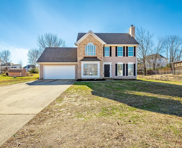 colonial home with a front lawn and a garage