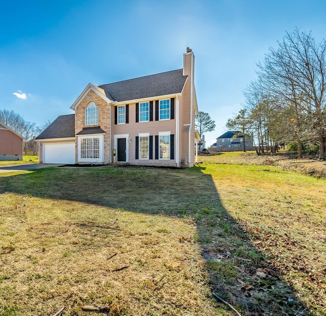 colonial home featuring a garage and a front lawn