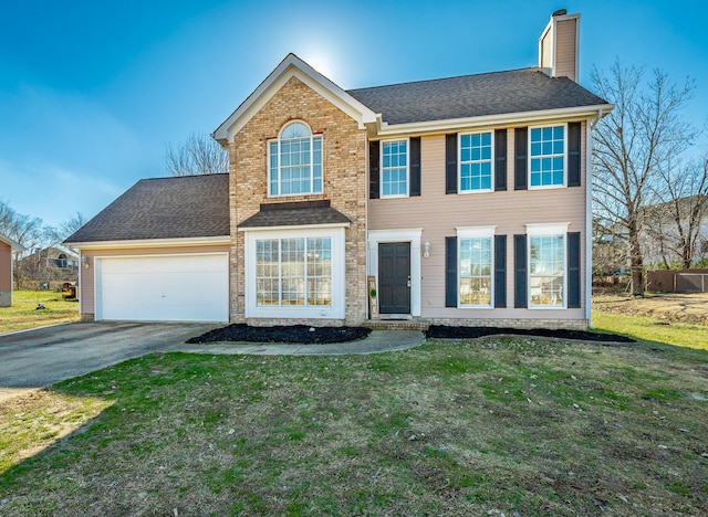 colonial inspired home featuring a front lawn and a garage