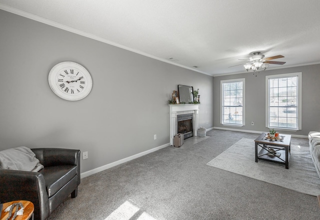 living room featuring carpet flooring, ceiling fan, and crown molding