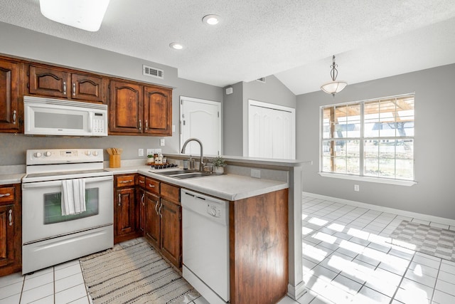 kitchen with kitchen peninsula, a textured ceiling, white appliances, and sink