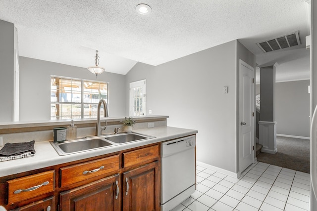 kitchen with dishwasher, light tile patterned floors, a textured ceiling, and sink