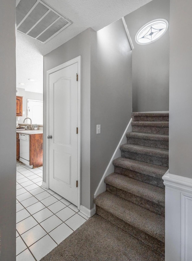 staircase with tile patterned floors