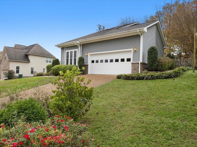 ranch-style home featuring a front yard and a garage