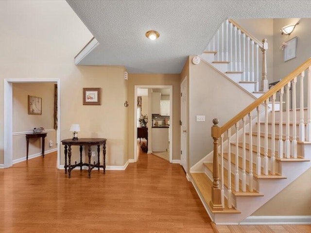 entrance foyer featuring hardwood / wood-style floors and a textured ceiling