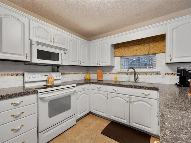 kitchen with backsplash, sink, white cabinets, and white appliances