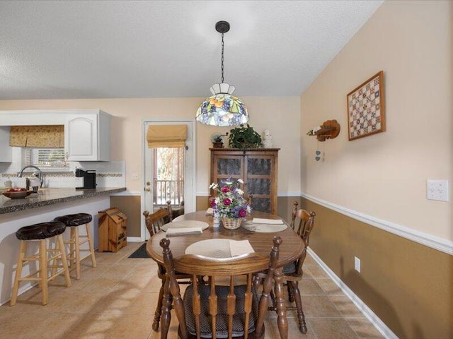 dining space with a textured ceiling