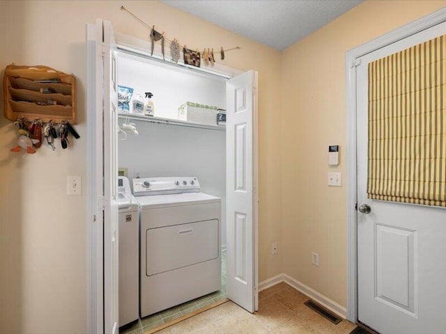 washroom with independent washer and dryer